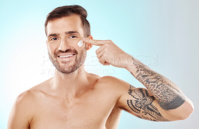 Buy stock photo Skincare, beauty and portrait of a man with cream isolated on a blue background in studio. Glow, dermatology and model applying lotion or sunscreen for cosmetic grooming and treatment on a backdrop