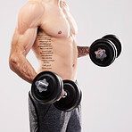 Arms muscle, dumbbells and bodybuilder man workout in a studio for fitness, exercise and power. Gray background, isolated and gym model weightlifting, bodybuilding and doing body wellness training