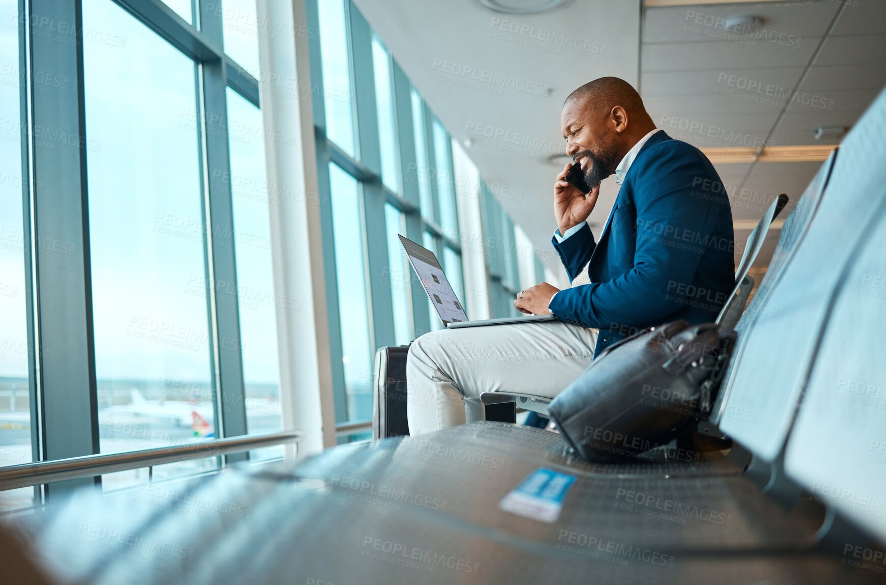 Buy stock photo Phone call, travel and businessman on a laptop in the airport for work company trip in the city. Technology, communication and African male employee on mobile conversation waiting to board his flight