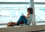 Airport, travel and black woman with tablet by window waiting for global flight, departure and transport. International plane, lobby and girl with digital tech for internet, schedule and social media