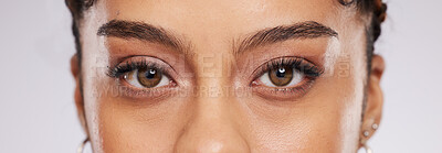 Eyes, vision and beauty with contact lens and black woman, eye care and cosmetics with closeup on studio background. Microblading, eyebrow and lashes, face and skin in portrait with optometry