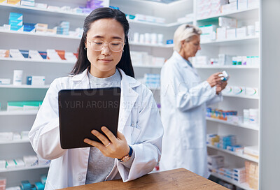 Buy stock photo Asian woman, tablet and pharmacist in pharmacy for healthcare or online consultation in drugstore. Medication, telehealth technology and female medical doctor with touchscreen for research in shop.