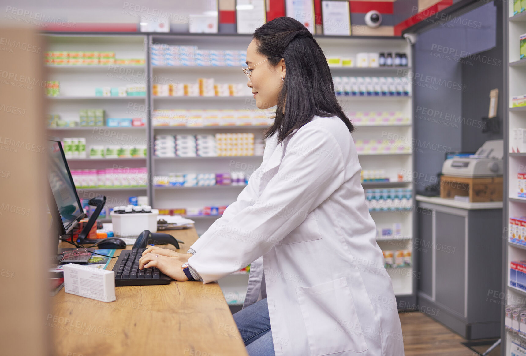 Buy stock photo Pharmacy, woman from Japan and checkout counter for prescription drugs and customer service. Healthcare, pills and asian pharmacist in retail store typing on computer to check stock inventory online.