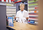Pharmacy, doctor and medicine prescription paper in retail store with mockup healthcare stock. Pharmacist woman reading info on pills, box or Pharma product for medical service, health and wellness