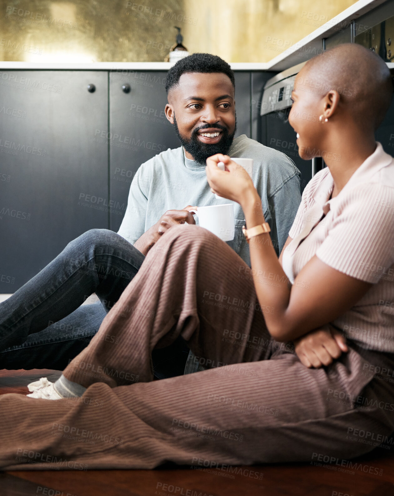 Buy stock photo Conversation, happy and African couple with coffee for peace, love and care on the kitchen floor. Communication, smile and black man and woman drinking tea while talking about their relationship
