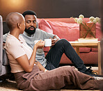 Coffee, love and valentines day with a black couple sitting on the living room floor together for romance. Relax, date or romantic with a man and woman spending time in their home for bonding