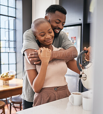 Buy stock photo Morning, hug and African couple making coffee for energy, drink and routine in the kitchen. Smile, affection and black man and woman hugging while preparing tea, bonding and relaxing in their home