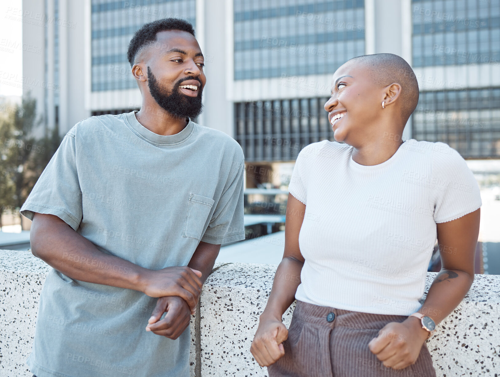 Buy stock photo Laughing, black people and couple of friends in a city with happiness and conversation outdoor. Urban lifestyle talk, happy woman and communication at date with partner and smile from discussion