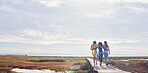 Relax, happy and boardwalk with friends at beach for travel vacation, support or summer break with blue sky mockup. Diversity, holiday and nature with women walking together for bonding, hug or peace