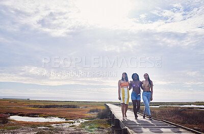 Buy stock photo Travel, freedom and friends walking while on vacation, adventure or outdoor journey in nature. Summer, bonding and women on a walk while on holiday or weekend trip with sky and mockup in countryside.