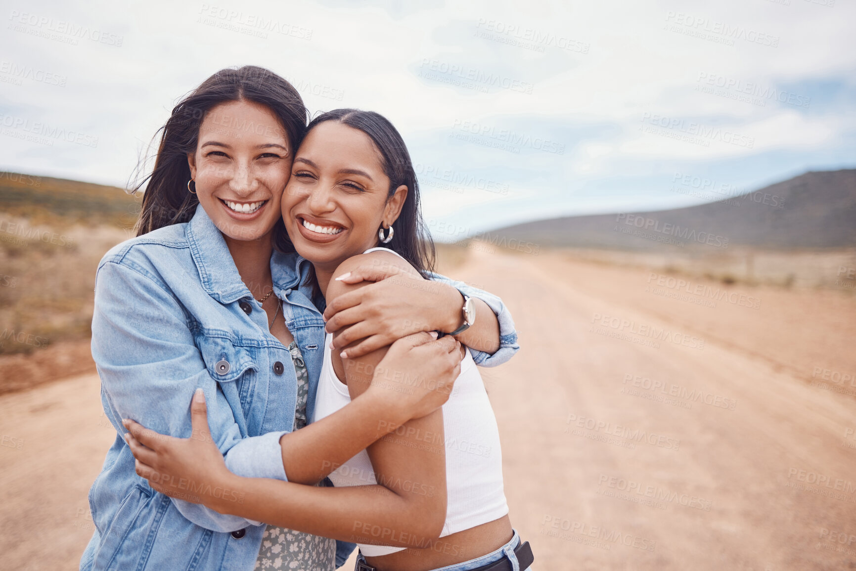 Buy stock photo Portrait, hug and friends on a road trip with mockup on a dirt road outdoor in nature for adventure together. Desert, travel or freedom with a young woman and friend hugging outsode on holiday