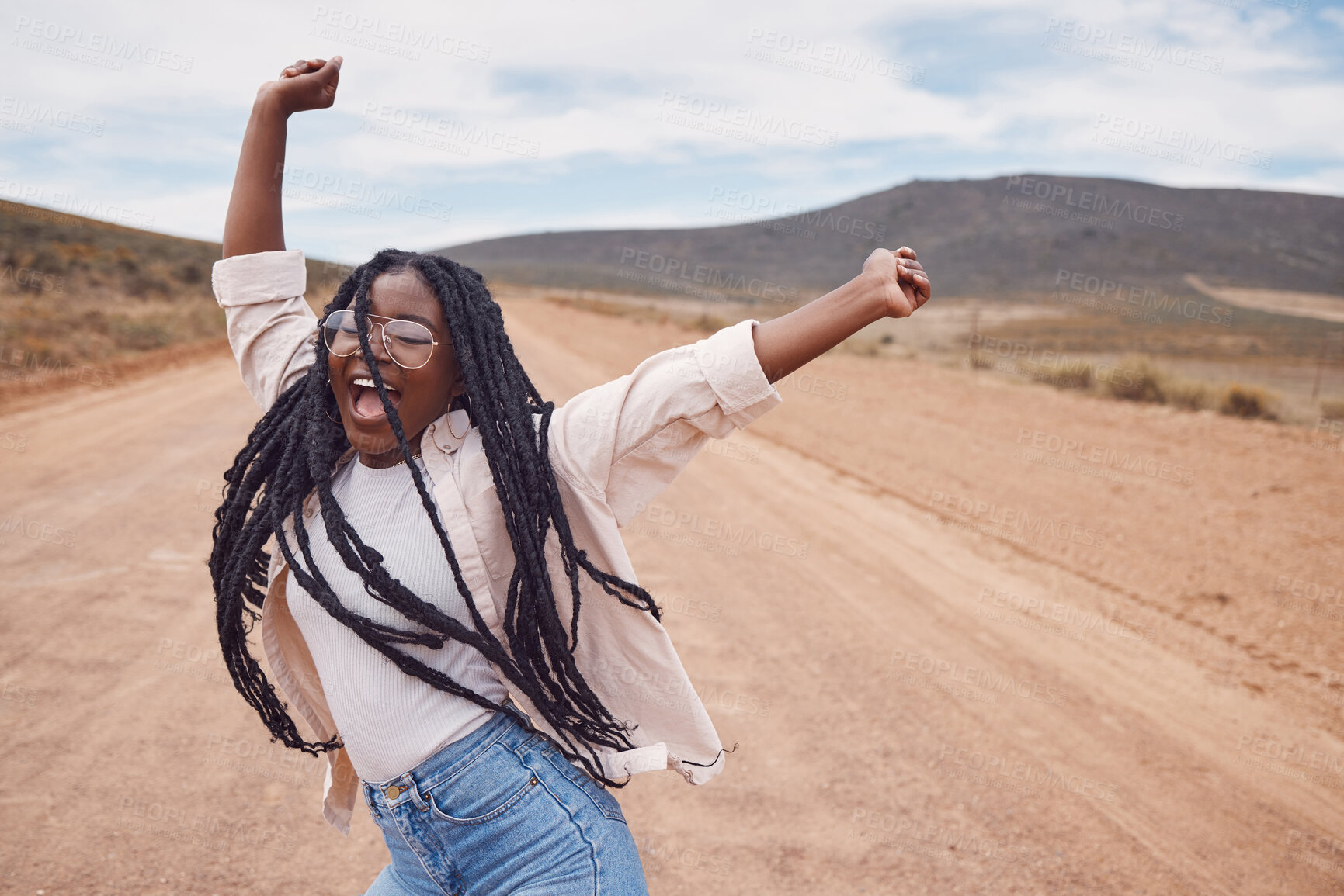 Buy stock photo Freedom, excitement and mockup with a black woman dancing in the desert for fun during a road trip. Travel, dance and mock up with a young female enjoying her holiday or vacation outside in nature