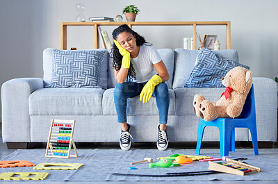Buy stock photo Tired, cleaning and black woman in living room with chaos and stress from toys at home. Cleaner, stress and burnout from housekeeping work on a lounge couch ready for sleeping from anxiety and mess