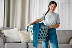 Laundry, clothes and portrait of woman with basket for cleaning, housekeeping and maintenance at home. Housework, washing and happy girl in living room carry container for linen, fabric and material