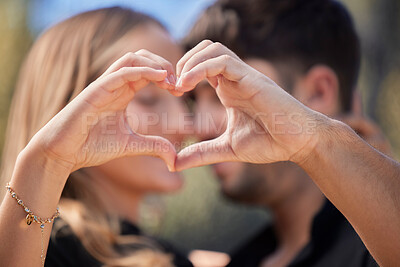 Buy stock photo Happy, heart shape and couple hugging in nature while on romantic date for valentines day or anniversary. Intimacy, affection and young man and woman embracing with love hand sign or gesture together