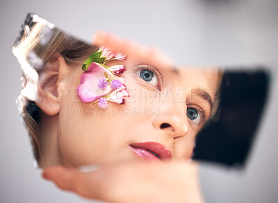 Buy stock photo Beauty, reflection and woman with flowers, skincare and natural cosmetics for morning routine, grooming and treatment. Mirror, female and lady with makeup, plants or floral with dermatology or luxury
