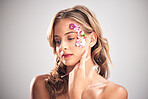 Beauty, flower pattern and face of woman for natural cosmetics, skincare wellness and makeup products. Spring, art and girl with petals for spa aesthetic, luxury facial and cosmetology in studio
