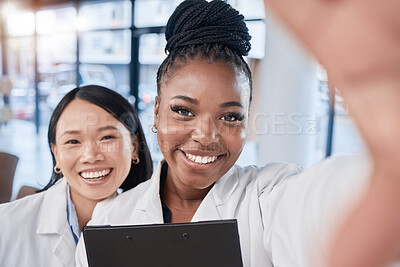 Buy stock photo Doctor, team selfie and women friends with smile, checklist and happy at clinic for profile picture. Medic, asian and black woman with team building, support and solidarity in hospital for portrait