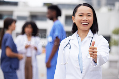 Buy stock photo Thumbs up, happy and portrait of a doctor outdoor of the hospital with a leadership mindset. Happy, smile and Asian female healthcare worker with a success or agreement gesture in a medical clinic.