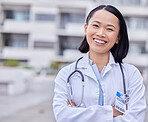 Leadership, happy and portrait of a doctor by hospital with success after surgery or consultation. Happiness, smile and Asian female healthcare worker with confidence standing outdoor medical clinic.