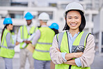 Portrait, Asian woman arms crossed and engineer outdoor, building and inspector with smile, new project and deadline. Face, female employee and manager with hard hat, vest and construction inspector