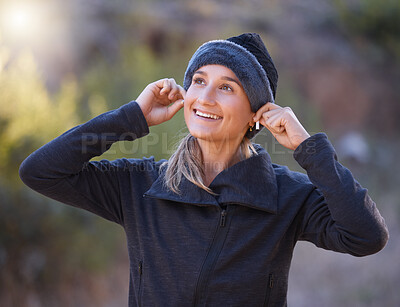Buy stock photo Music, earphones and woman hiking in nature outdoors for health, exercise and fitness. Winter sports, thinking and happy female hiker streaming radio, podcast or audio after training in forest park.