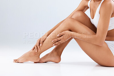 Buy stock photo Woman, skincare and beauty legs for wellness, laser hair removal and studio background. Female model, leg and body cosmetics, shine and epilation for salon waxing, aesthetic pedicure and mockup glow