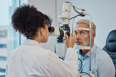 Buy stock photo Vision, eye exam and healthcare with a doctor woman or optometrist testing the eyes of a man patient in a clinic. Hospital, medical or consulting with a female eyesight specialist and senior male