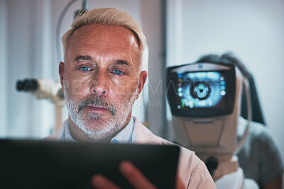 Buy stock photo Optometry, healthcare and optometrist doing a eye test in the clinic for eyecare or vision. Medical, tablet and senior male ophthalmologist doing optic research on a mobile device in a optical store.