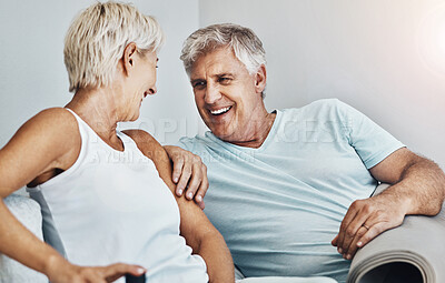 Buy stock photo Love, laugh and retirement with a senior couple sitting in the living room of their home together. Happy, smile or relax with a mature man and woman laughing while bonding on the couch in a house