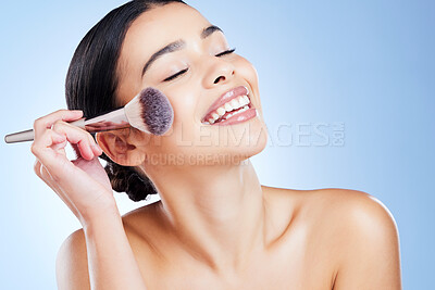 Buy stock photo Makeup, happy and woman with beauty brush on blue background for cosmetics, powder and foundation. Skincare, spa aesthetic and girl face with cosmetology tool for facial product, treatment and salon