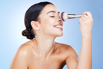 Buy stock photo Makeup, beauty and woman with brush happy on blue background for cosmetics, powder and foundation. Cosmetology, skincare and girl face with application tools for facial products, treatment and salon