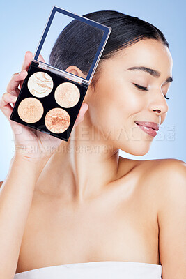 Buy stock photo Beauty, makeup and woman with palette and smile on blue background for cosmetics, powder and foundation. Skincare, spa aesthetic and face of girl with cosmetology highlighter, product and facial glow