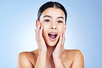 Skincare, shock and portrait of a woman in a studio with a beauty, natural and face routine. Surprise, health and female model from Brazil with a shocking facial treatment isolated by blue background