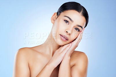 Buy stock photo Portrait, aesthetic and mock up with a model black woman in studio on a blue background for skincare. Face, beauty and spa with an attractive young female posing next to blank or empty mockup space