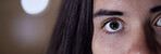 Eye, half and portrait of face of woman with focus, serious and looking intense isolated in blurred background. Detail, vision and mysterious person or female at night, evening or late with mockup