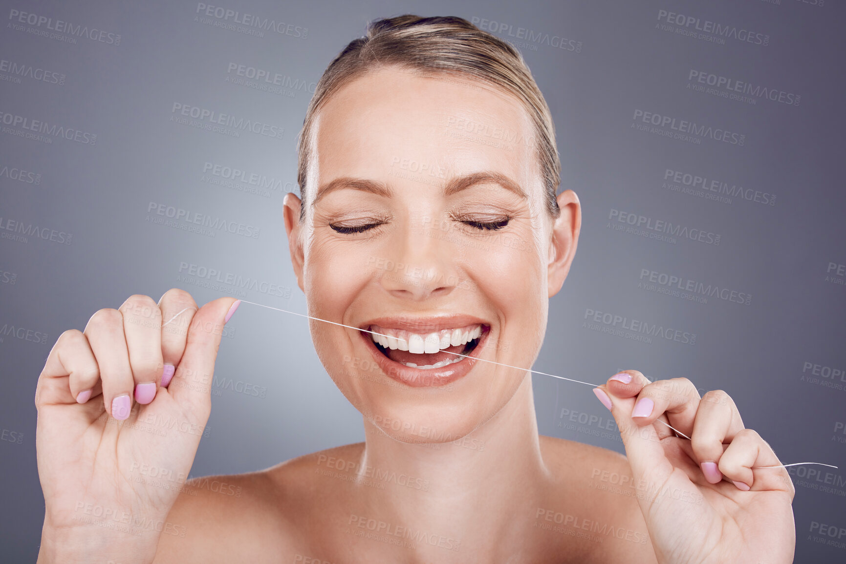 Buy stock photo Floss, teeth and smile of woman in studio for beauty, healthy dental hygiene and background. Happy female model, tooth flossing and cleaning mouth for treatment, fresh breath and oral maintenance