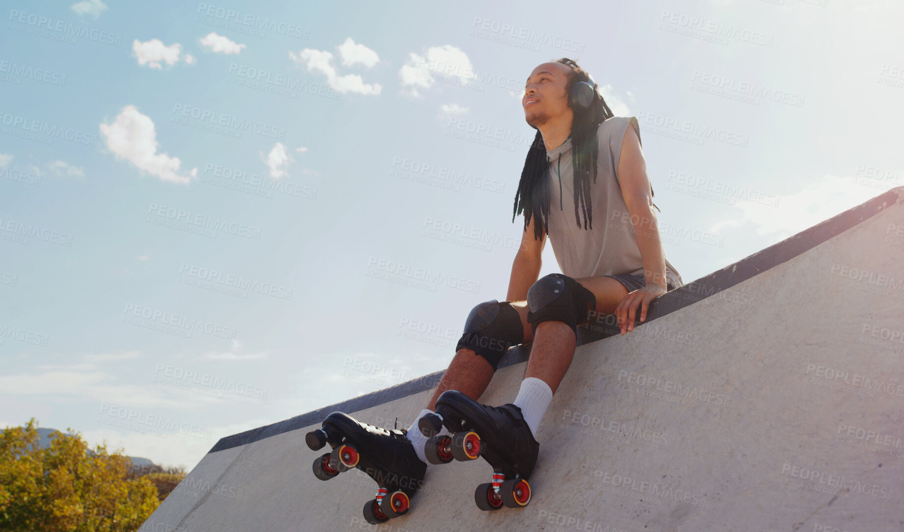 Buy stock photo Music, relax and man rollerskating at a park, thinking and sitting in peace in Australia. Freedom, idea and person planning to skate on a ramp with audio from headphones for motivation in nature
