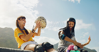 Buy stock photo Rollerskate, skatepark and fun with a couple of friends sitting outdoor on a ramp for recreation together. Fitness, diversity or sports with a man and woman bonding outside for an active hobby
