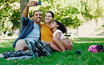 Interracial family selfie, girl and park with rollerblades, bonding or smile for profile picture, happy or holiday. Black man, mom and child for happiness, hug or diversity for social media on grass