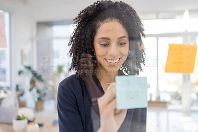 Buy stock photo Writing, thinking and planning by black woman in office for agenda, calendar or schedule on sticky note. Creative, strategy and lady for idea for future, vision or innovation, idea or problem solving