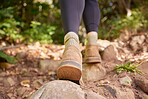 Ground, woman shoes and hiking in forest, nature and rock path for wellness, exercise and outdoor adventure. Hiker girl, boots and freedom in woods, forrest and walk to explore landscape on holiday