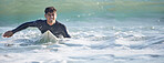Surfing, man and swimming in sea ocean of summer adventure, nature freedom or mockup banner. Happy young surfer guy, board and waves in water, beach and relax for holiday, sunshine travel or wellness