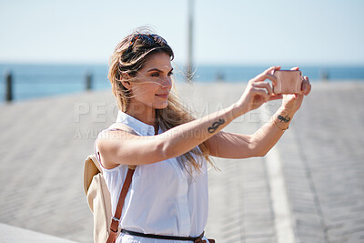 Buy stock photo Travel, selfie and woman relax at beach, calm and posing for photo on blurred background. Sightseeing, girl and social media influencer with update post for blog, profile picture or live streaming