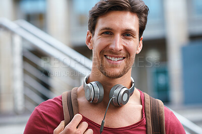 Buy stock photo Portrait, happy and man in a city for travel, relax and vacation against a blurred background. Smile, face and travelling man in town, cheerful and excited while streaming music, radio or podcast