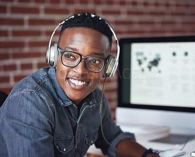 Buy stock photo Headphones, happy and black man with a smile in office while listening to music, radio or podcast. Happiness, excited and African male employee a streaming song or playlist while working in workplace