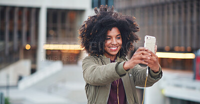 Buy stock photo Black woman, city and selfie with afro, phone or smile for social media profile picture. Happy gen z girl, influencer or smartphone for blog, post or networking app on rooftop balcony for travel