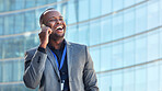 African american businessman using smartphone talking on mobile phone in city