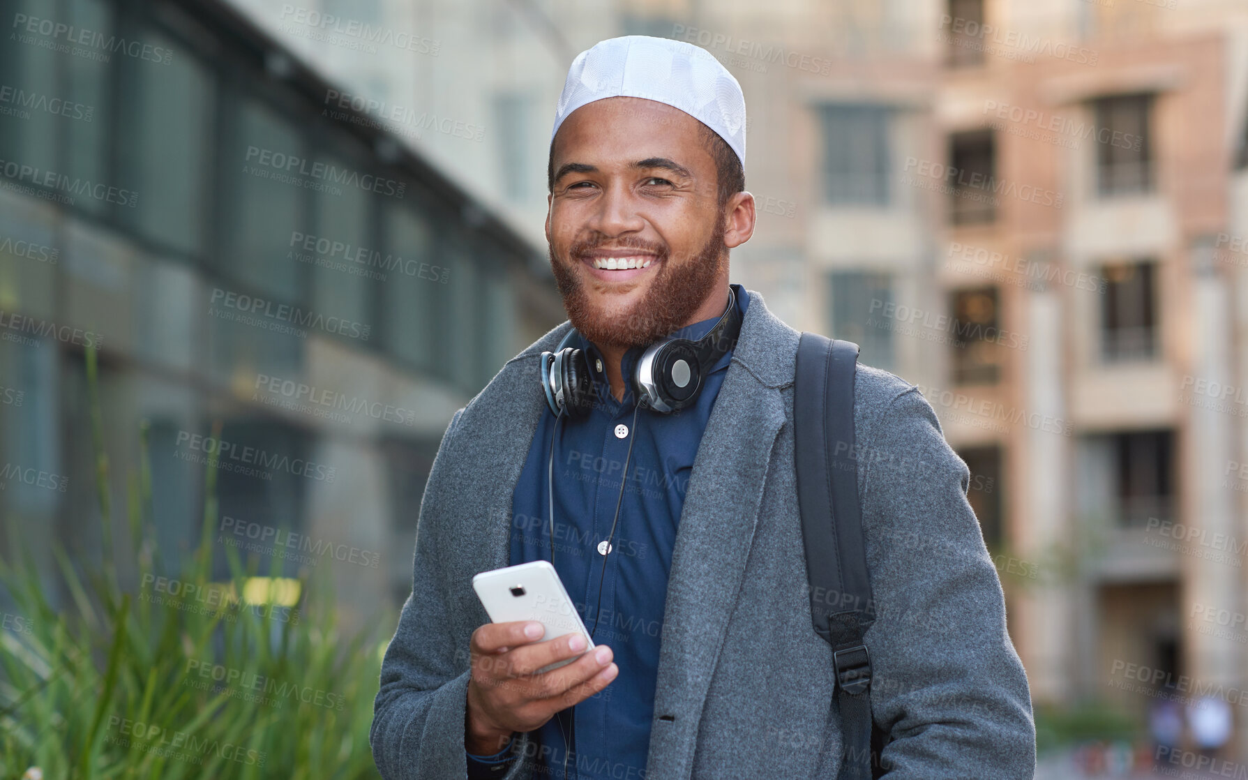 Buy stock photo Portrait, phone and muslim with an man in the city on his morning commute listening to music during the day. Mobile, contact and tradition with a happy islamic male walking alone in an urban town