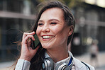 Happy business woman talking using smartphone having phone call conversation in city